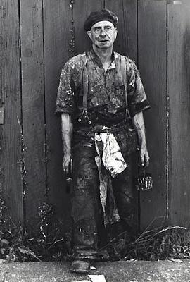 Man painting his fence