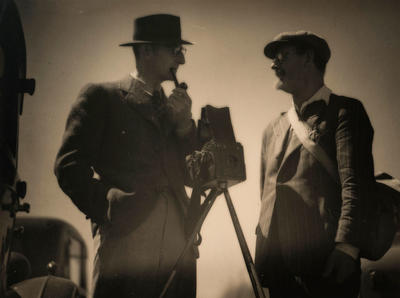 (Two men and a camera on tripod)