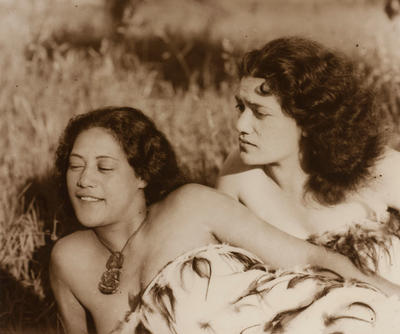 (Two young Maori women outdoors in traditional dress)
