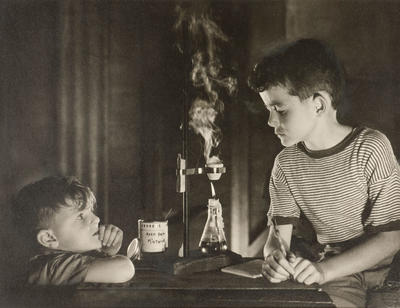 The amateur scientists (two boys with makeshift bunsen burner)
