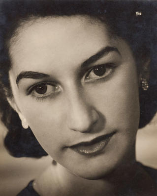 (Cropped head shot of young dark haired woman)