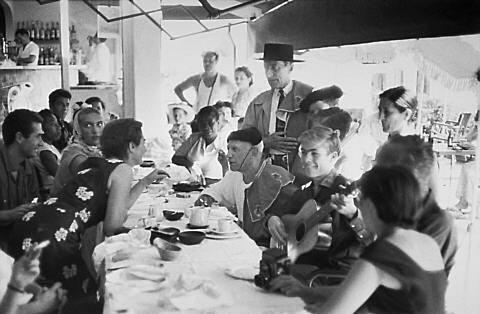 At the cafe - Cocteau with hat and cape