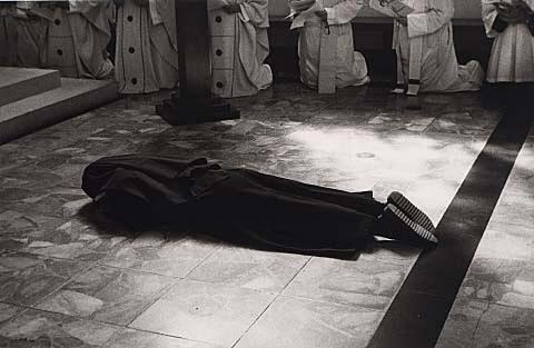 During the ceremony of her final profession, a sister lies in front of the altar while the community and the congregation say a litany or prayer of intercession to the angels and saints