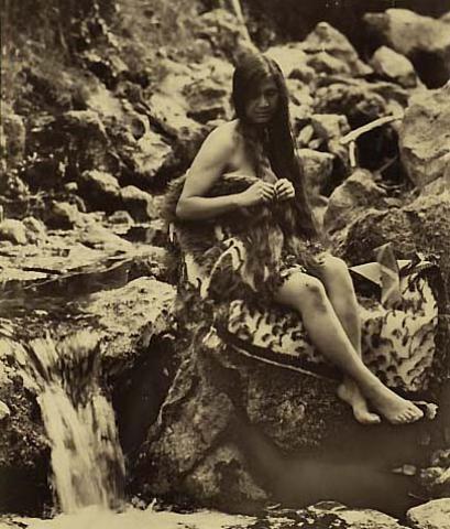 Maori woman beside stream (I)