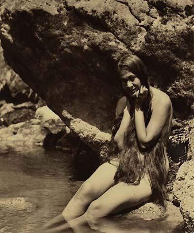 Maori woman beside stream (III)
