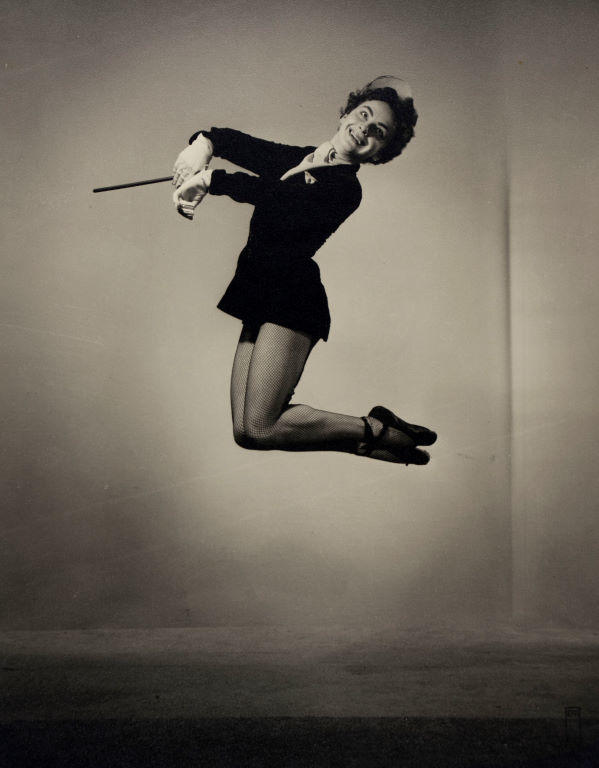 (Female dancer jumping with baton?)