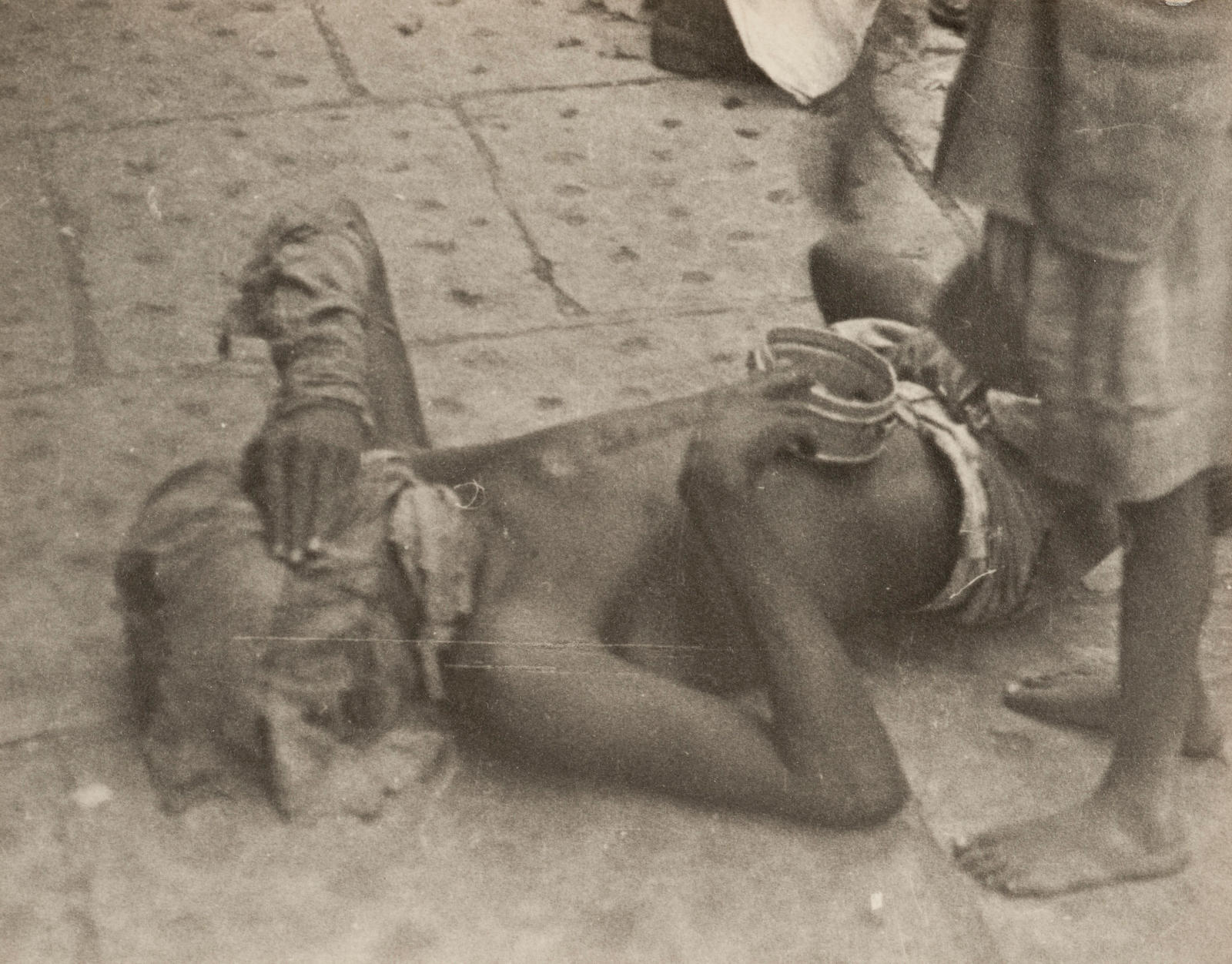 Bombay (beggar on ground, with face covered)