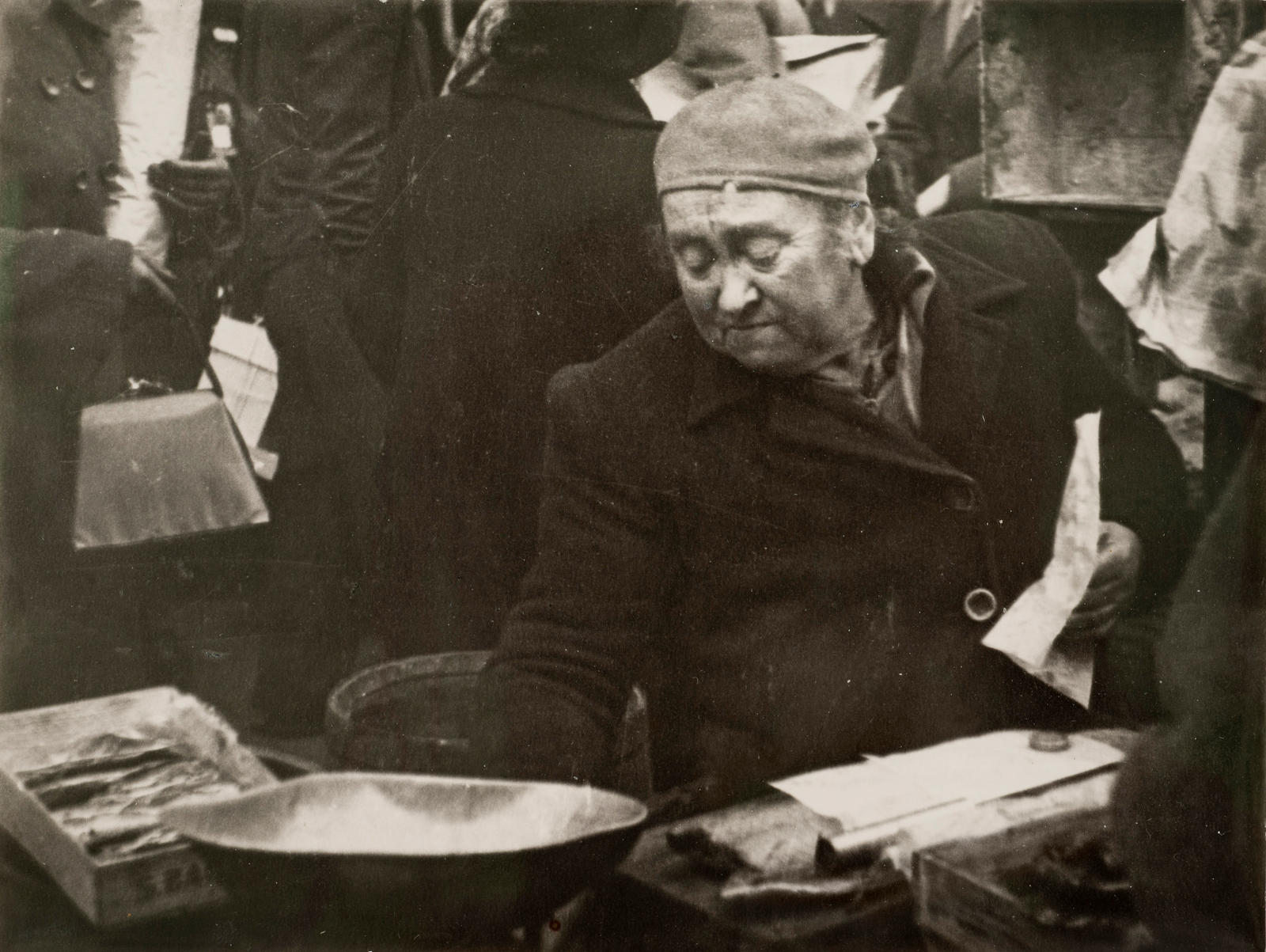 (Street scene - woman polishing metal?)
