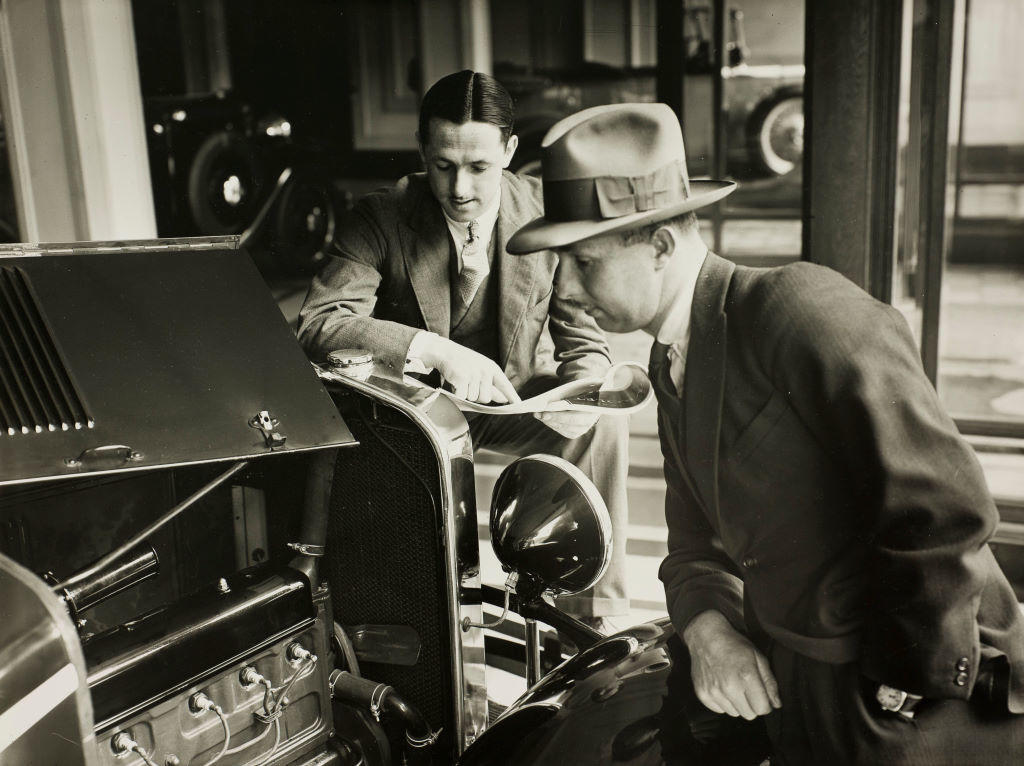 (Two men examining motorcar - Chevrolet?)