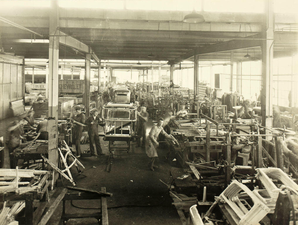 (Factory men building chevrolet chassis)
