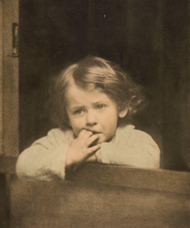 (Young girl or boy at a window)