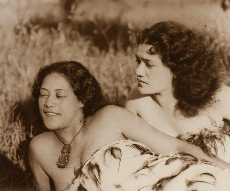 (Two young Maori women outdoors in traditional dress)