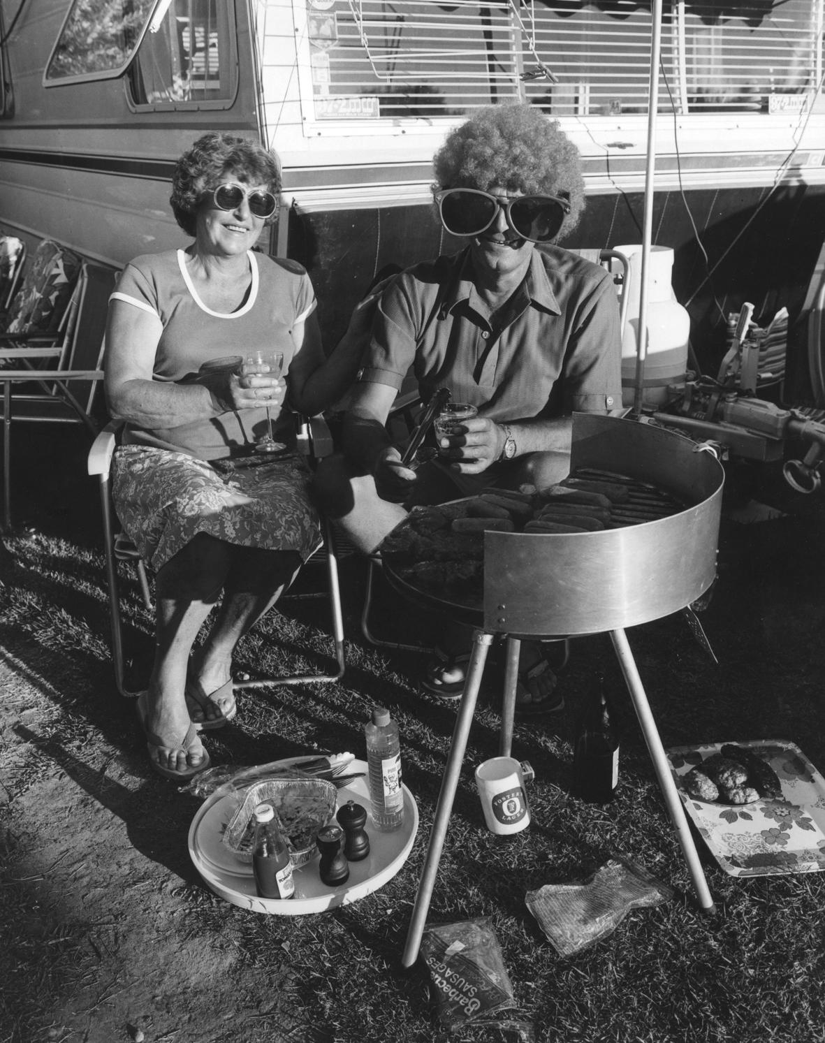 The Hibiscus Coast Project, Campers and Lifesavers: Man with outsized sunglasses barbequing sausages