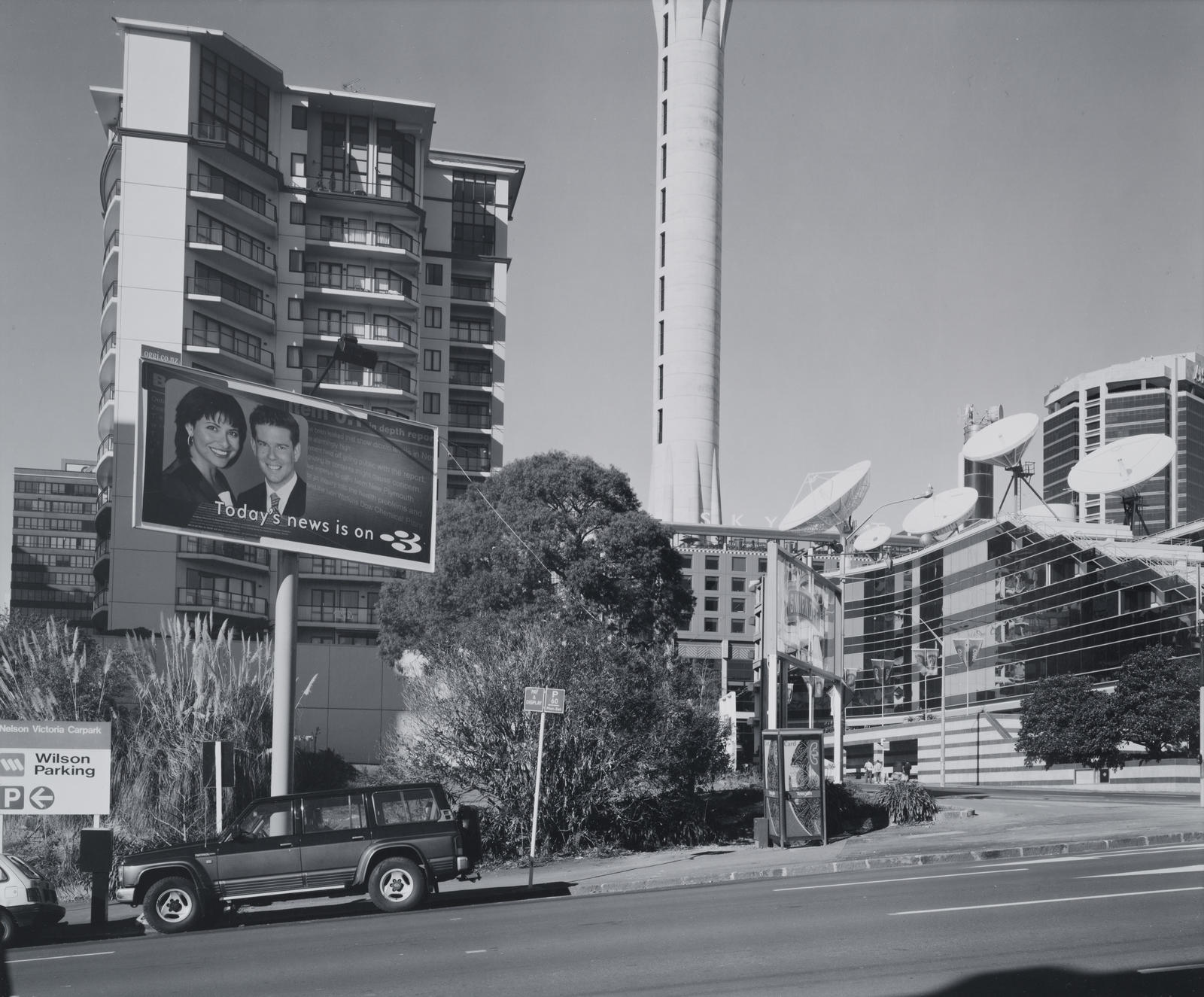 Temporary carpark with TVNZ Television Centre, Apartment and billboard. Corner Nelson and Victoria streets. CBD, Auckland. 1 July 2001.